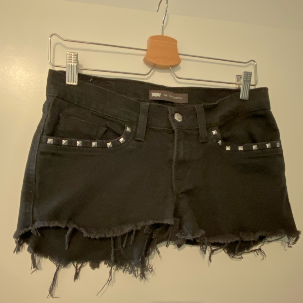 Levi’s black denim shorts with studded pocket detail.